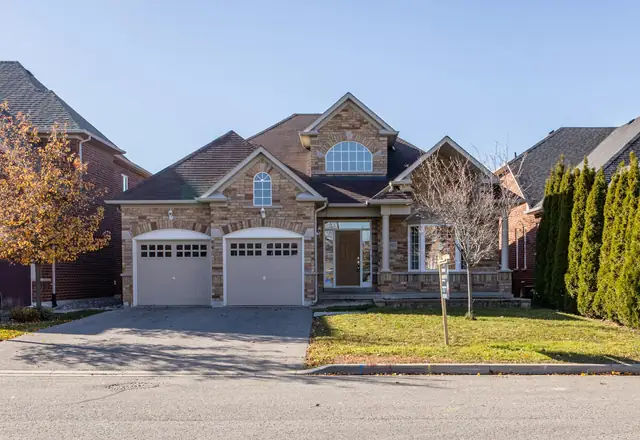 Two-story stone and stucco home with a two-car garage