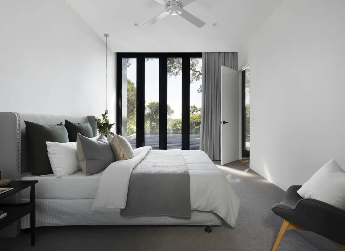 Bright primary bedroom with a large window
