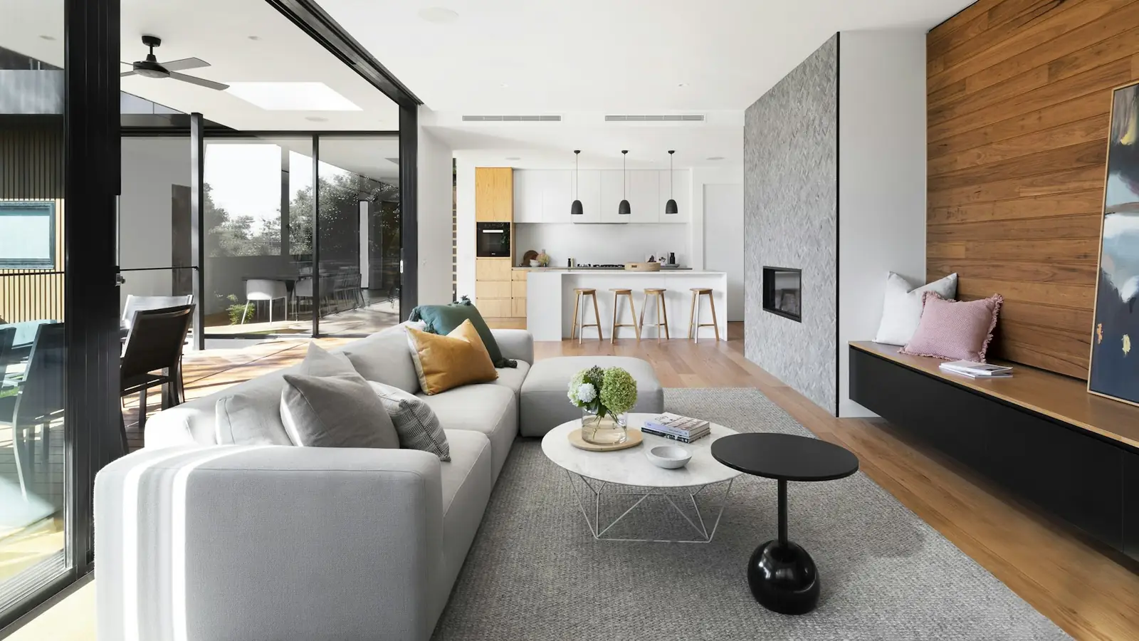 Living room with kitchen and dining beyond, seen from the garden doors